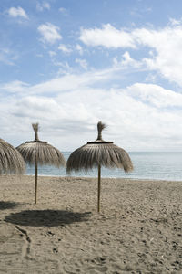 Gazebo on beach against sky