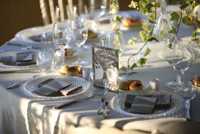 Table set for the wedding reception. plate cutlery and napkins, with flowers in the centerpiece