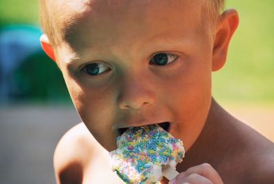 Close-up of cute boy eating ice cream
