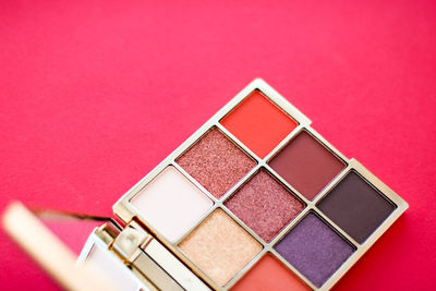 Close-up of multi colored beauty product against pink background