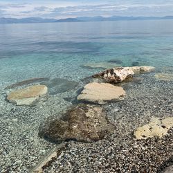 High angle view of rocks on beach against sky