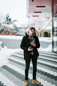 Full length of man standing on snow covered