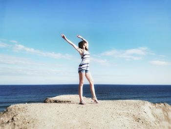Rear view of woman standing on beach