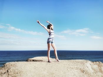 View of woman standing in front of shore