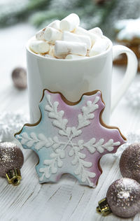 Christmas cocoa, gingerbread cookies and decorations. white wooden background.