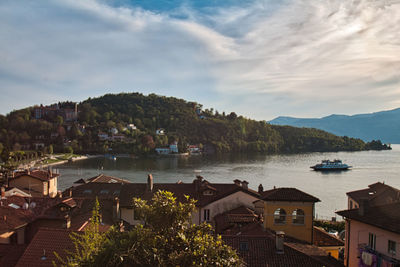 High angle view of townscape by lake against sky