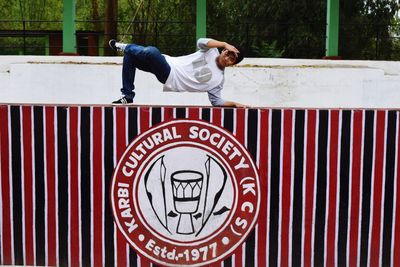 Man practicing stunt on retaining wall