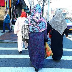 Woman walking on sidewalk