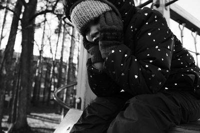 Midsection of man sitting in park
