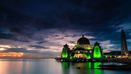 View of illuminated building against cloudy sky