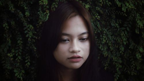 Close-up of beautiful young woman looking down