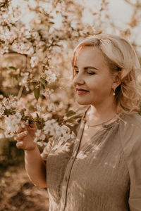 Portrait of young woman holding christmas tree