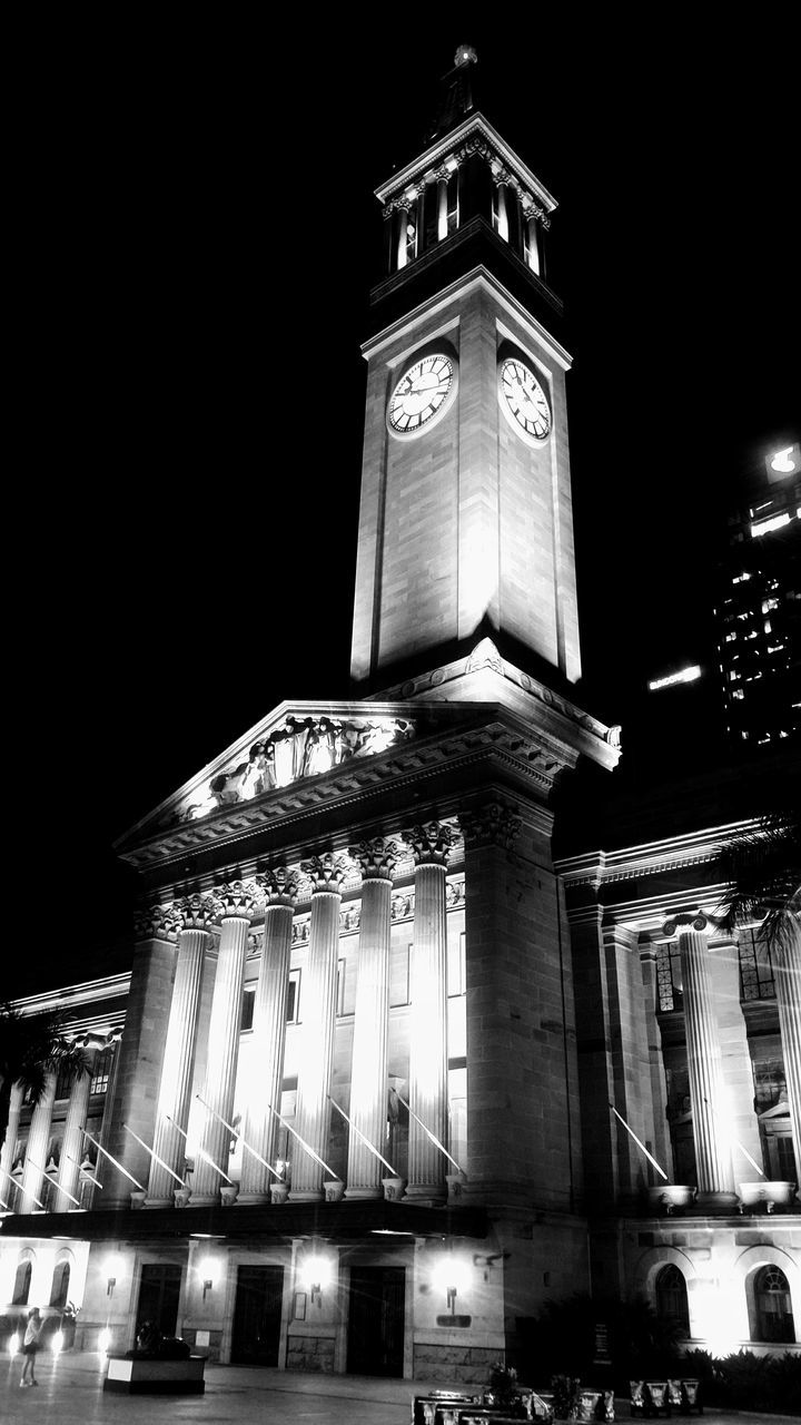 LOW ANGLE VIEW OF ILLUMINATED CLOCK TOWER