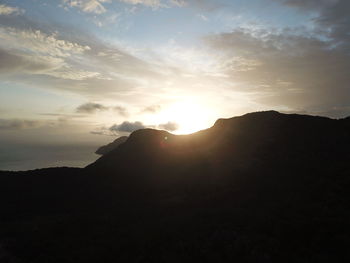 Scenic view of silhouette mountains against sky during sunset