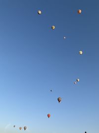 Low angle view of hot air balloons against sky in pamukkale