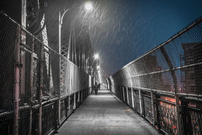 Illuminated railing against sky at night