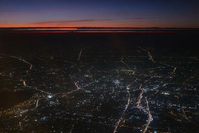 Scenic view of illuminated landscape against sky at night