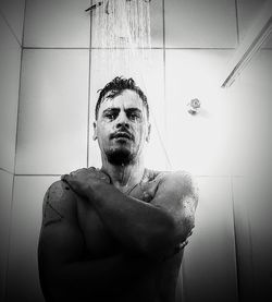 Portrait of young man in bathroom