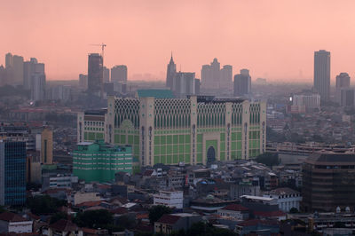 Cityscape against sky during sunset