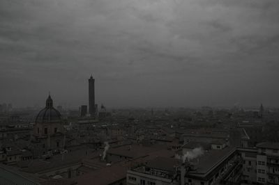 Cityscape against cloudy sky