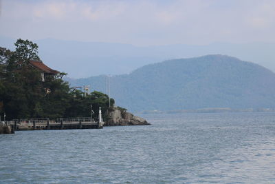 Scenic view of sea and buildings against sky