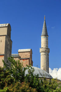 Low angle view of building against clear blue sky