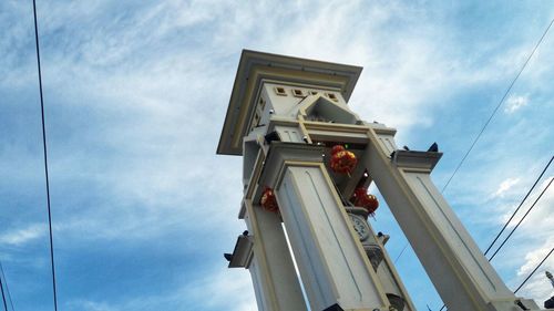 Low angle view of statue against building against sky