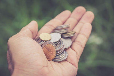 Close-up of hand holding coins