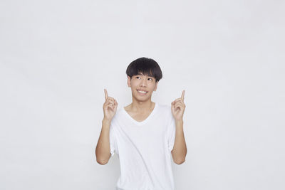 Portrait of a smiling young woman over white background