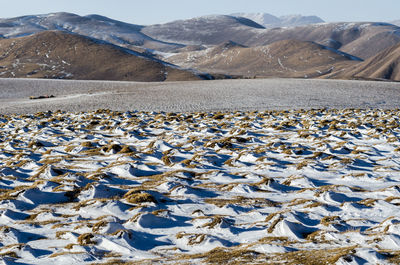 Aerial view of snowcapped mountains against sky