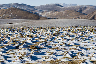 Aerial view of snowcapped mountains against sky