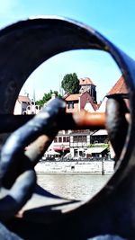 Close-up of hand against building in city