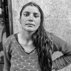 Portrait of beautiful woman against wall