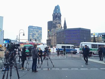 People in city against clear sky