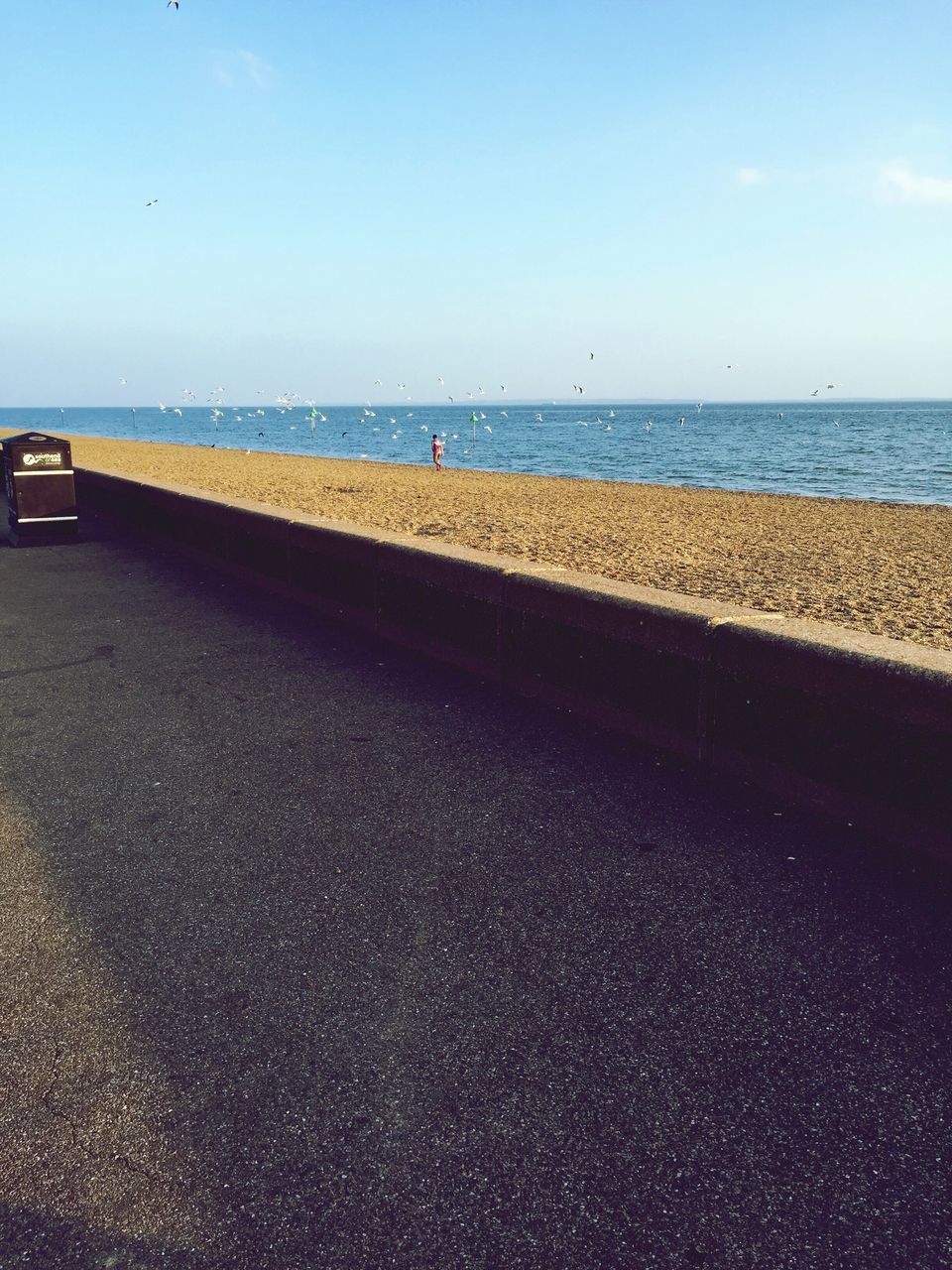 sea, horizon over water, water, beach, sky, shore, tranquility, tranquil scene, blue, scenics, transportation, nature, sand, beauty in nature, incidental people, day, outdoors, built structure, copy space, clear sky