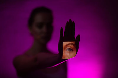 Portrait of woman holding pink flower