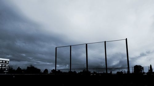 Low angle view of silhouette bridge against sky