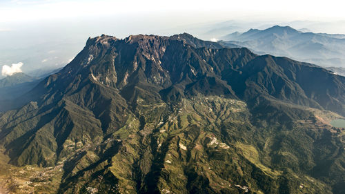 Scenic view of mountain range against cloudy sky