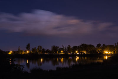 Scenic view of lake against sky at night