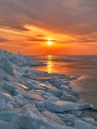 Scenic view of sea against orange sky during sunset