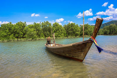 Boat moored in sea against sky