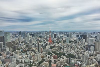 High angle view of cityscape against cloudy sky