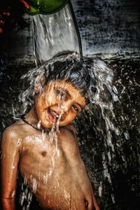 Water pouring over boy