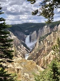 Scenic view of waterfall against sky