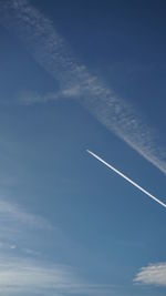 Low angle view of airplane flying against sky