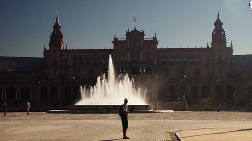 Water fountain against historic building at plaza de espana