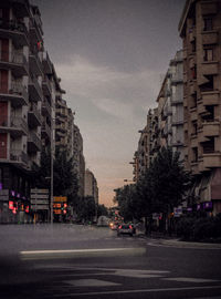 City street and buildings against sky