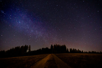 Scenic view of field against sky at night