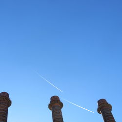 Low angle view of clock tower against clear blue sky