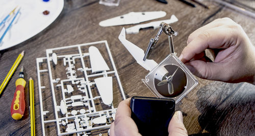 War plane toy model building or construction, handcraft on table with different materials. 